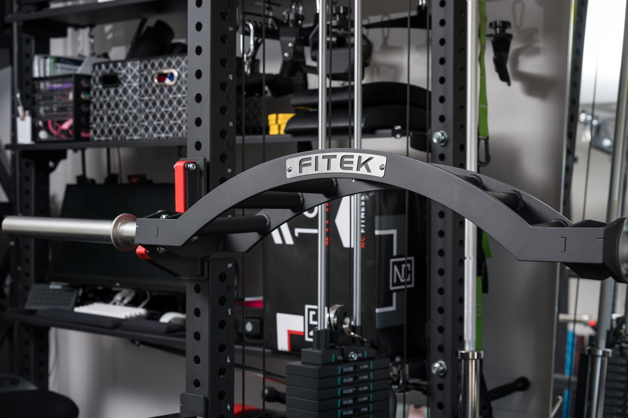 FITEK Cambered Multi-Grip Barbell with laser-cut stainless steel logo plate and knurled handles