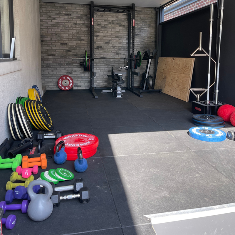 Messy home gym floor before FITEK storage